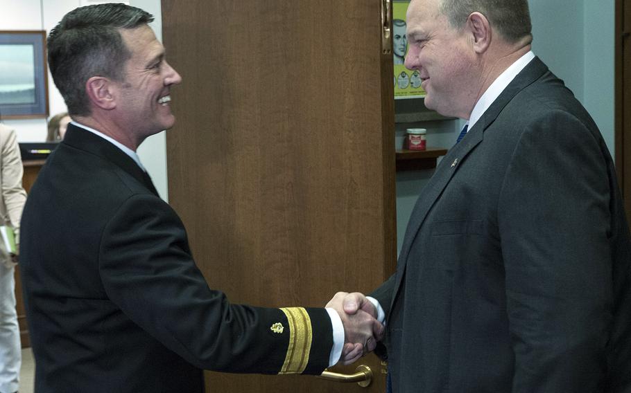 Rear Adm. Ronny Jackson, President Donald Trump's nominee to succeed David Shulkin as Secretary of Veterans Affairs, is greeted by Senate Veterans' Affairs Committee Ranking Member Jon Tester, D-Mont., in Tester's Capitol Hill office, April 17, 2018.