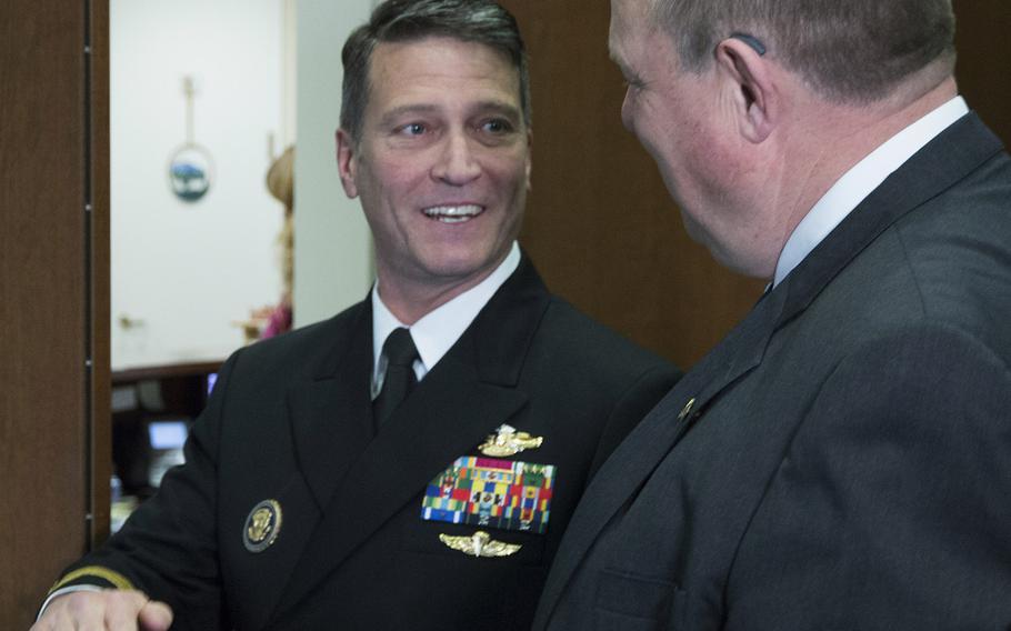 Rear Adm. Ronny Jackson, President Donald Trump's nominee to succeed David Shulkin as Secretary of Veterans Affairs, talks with Senate Veterans' Affairs Committee Ranking Member Jon Tester, D-Mont., in Tester's Capitol Hill office, April 17, 2018.