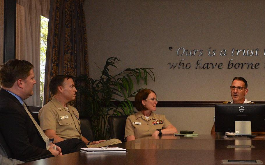 Capt. Joel Roos (center), commanding officer, Naval Medical Center San Diego, speaks with Deputy Secretary of Veterans Affairs Scott Blackburn (far left) on June 15, 2017.