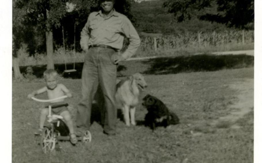 U.S. Army 1st Lt. Garlin M. Conner with his son Paul and dogs at the family farm.  