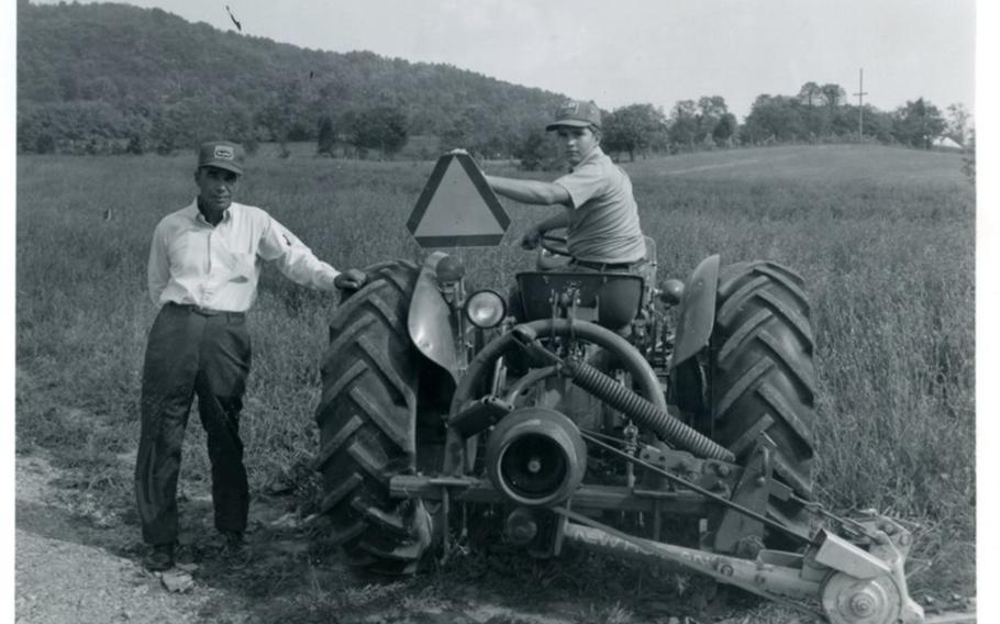 U.S. Army 1st Lt. Garlin M. Conner with his son Paul, on the family farm in the 1970s. 