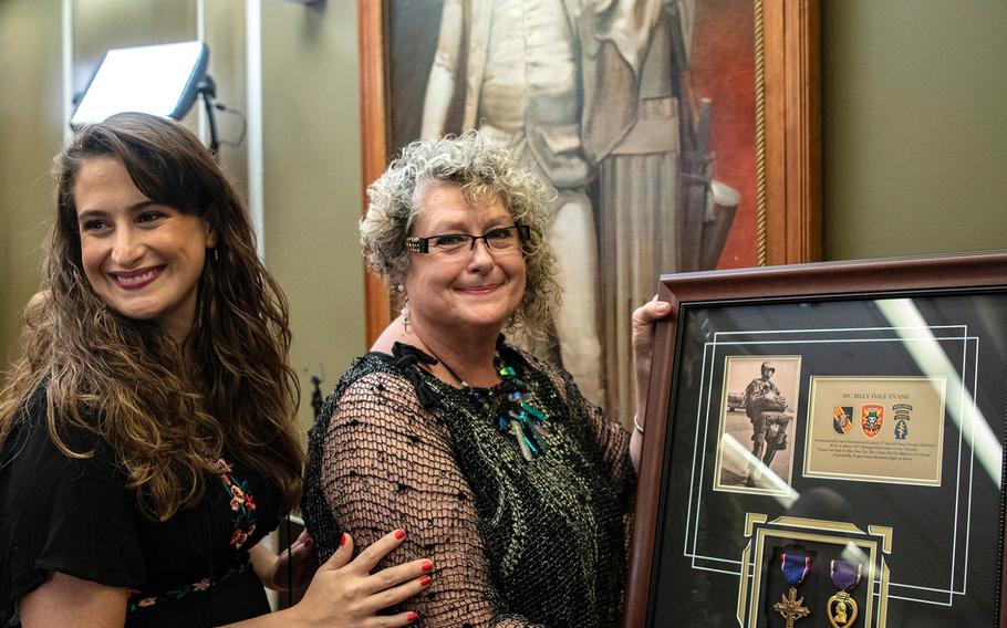 Myrtle Totty holds a glass-encased framed board containing military medals and paraphernalia she received during a ceremony in Washington D.C. on Purple Heart Day on Tuesday, Aug. 7, 2018. Totty received the framed board that contained a Purple Heart Medal that had been awarded to her father, Vietnam veteran Sgt. 1st Class Billy Dale Evans. With Totty is her daughter Molly Mason.