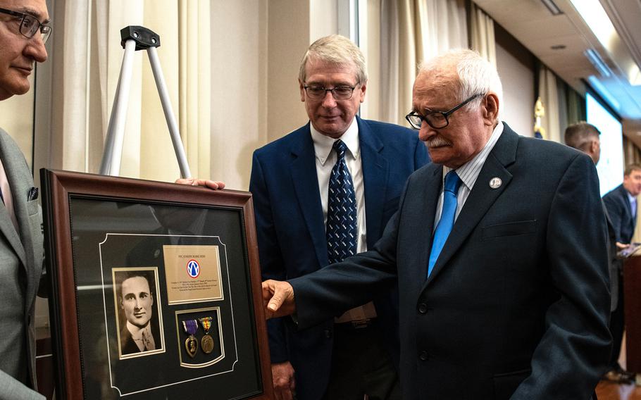 Air Force veteran Joseph M. Hish Jr., 90, holds back tears as he reaches out to touch a special gift he received during a ceremony in Washington D.C. on Purple Heart Day on Tuesday, Aug. 7, 2018. The glass-encased framed board contained military medals and paraphernalia belonging to Hish's father, World War I veteran Pfc. Joseph Mark Hish.