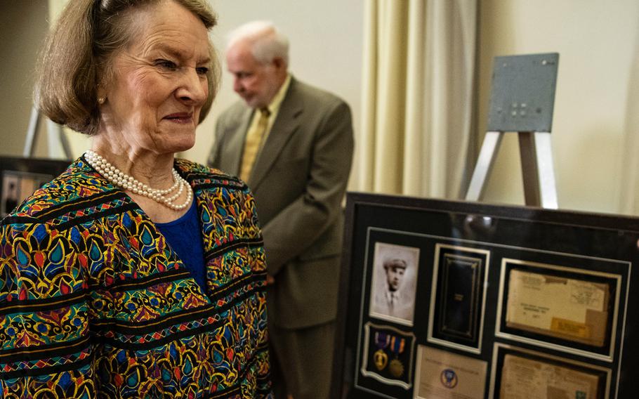 Marcia Trawick stands beside a glass-encased framed board containing military medals and paraphernalia during a ceremony in Washington D.C. on Purple Heart Day on Tuesday, Aug. 7, 2018. Trawick was given the gift which contained the Purple Heart that had been awarded to her uncle, World War II veteran Tech. Sgt. Thomas M Williams Jr.