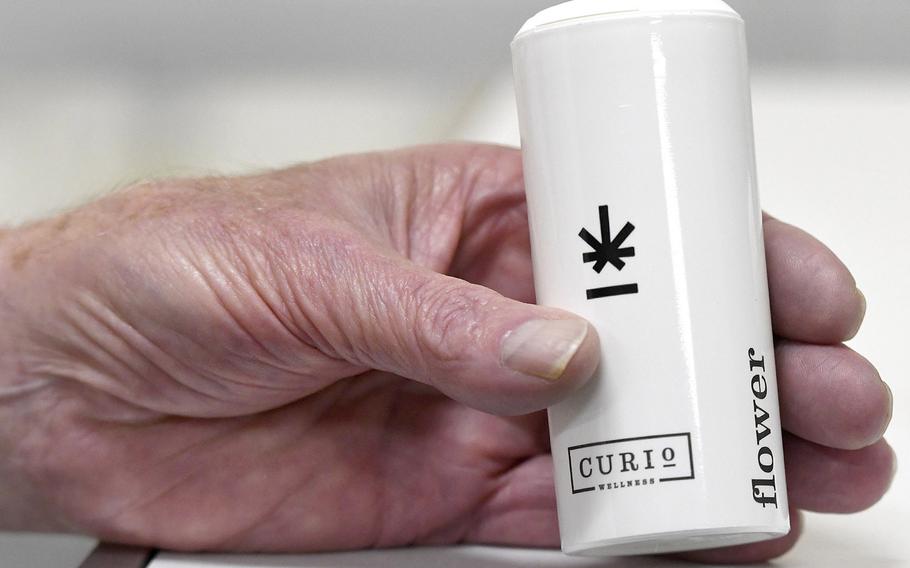 Jim Dunnigan, 84, holds a container of the medical marijuana he uses to treat his tremors, at Curio Wellness in Lutherville-Timonium, Md. Dunnigan uses the marijuana flower to make butter with which his wife bakes cookies for him to eat.