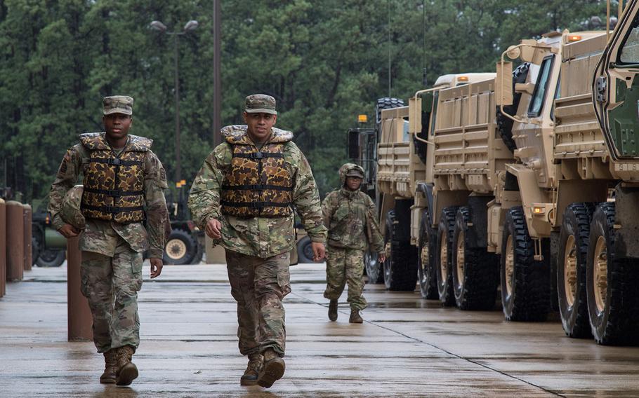 U.S. Army Pfc. Attlee Simmons (left) and Cpl. Ernesto Pacheco, both assigned to the  249th Composite Supply Company, 189th Combat Sustainment Support Battalion, 82nd Sustainment Brigade, 82nd Airborne Division, prepare to head out from Fort Bragg and provide aid to the surrounding areas of North Carolina that have been flooded by Hurricane Florence, Sept. 15, 2018. 