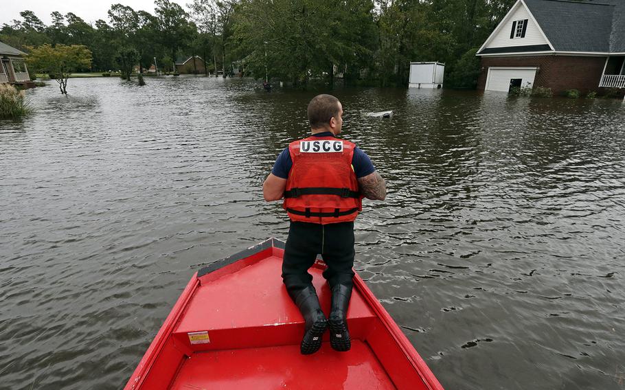 Petty Officer 2nd Class David Kelley patrols a flooded neighborhood in Lumberton, N.C., Sunday, Sept. 16, 2018, following flooding from Hurricane Florence. 