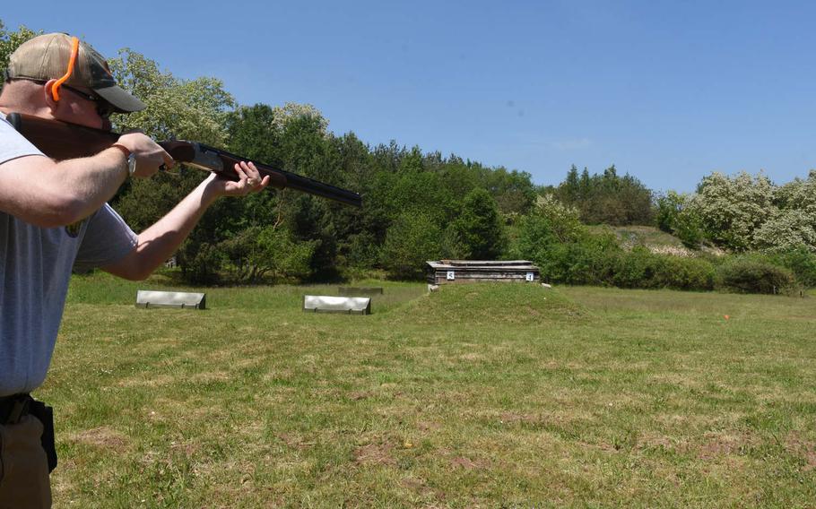 Brandon Cowell, the hunting coordinator for KMC Outdoorsmen, aims his shotgun at a flying clay at one of the ranges at the Kaiserslautern Rod and Gun Club in Kaiserslautern, Germany, in May.


