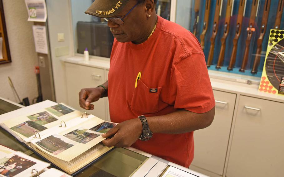 Calvin Churchill, a long-time Kaiserslautern Rod and Gun Club employee, pages through scrapbooks containing keepsakes from the club's storied history.

