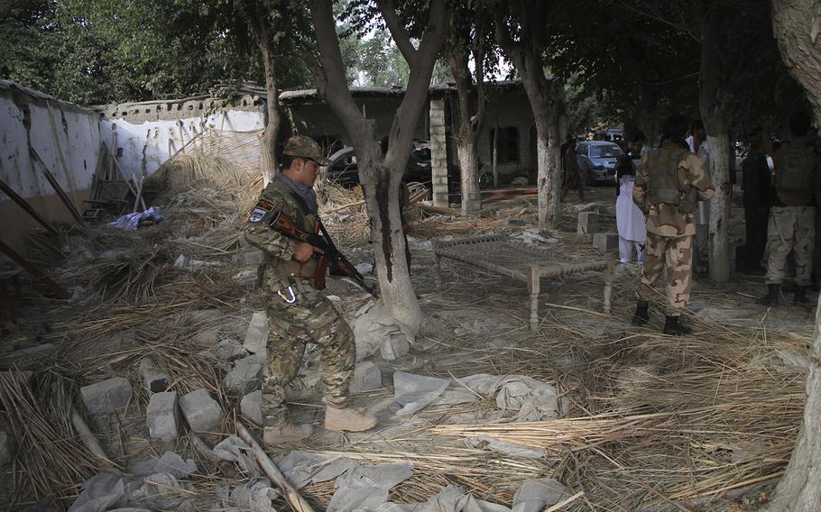 Afghan Security personnel inspect the site of a suicide attack in the Kama district of Nangarhar province, east of Kabul, Afghanistan, on Tuesday, Oct. 2, 2018. The suicide bomber struck an election rally on Tuesday, killing at least 13 people and wounding more than 30, a provincial official said. 