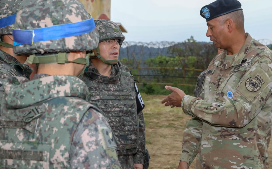 U.S. Army Gen. Vincent K. Brooks, Commander of United Nations Command, discusses the current land mine removal efforts ongoing at Arrowhead Hill in the Demilitarized Zone with Republic of Korea Army personnel. 