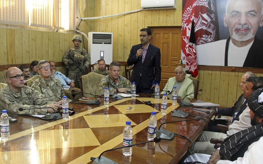 The head of NATO troops in Afghanistan, Gen. Scott Miller, center left, Kandahar Gov. Zalmay Wesa, center right, and their delegations attend a security conference, in Kandahar, Afghanistan, on Thursday, Oct. 18, 2018. Wesa was amongh three top officials in Afghanistan's Kandahar province who were killed when their own guards opened fire on them at the conference, the deputy provincial governor said. A Taliban spokesman said the target was Miller, who escaped without injury, according to NATO.