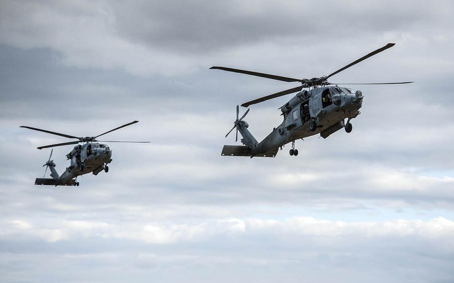 Two Navy HH-60H Seahawk helicopters assigned to Helicopter Sea Combat Squadron 85 prepare to land in Rockhampton, Australia, July 13, 2017.
