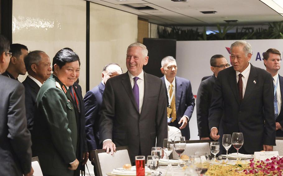 U.S. Defense Secretary Jim Mattis, center, and Singapore's Defense Minister Ng Eng Hen, front right, attend the ASEAN Defense Ministers' Meeting in Singapore Friday, Oct. 19, 2018.