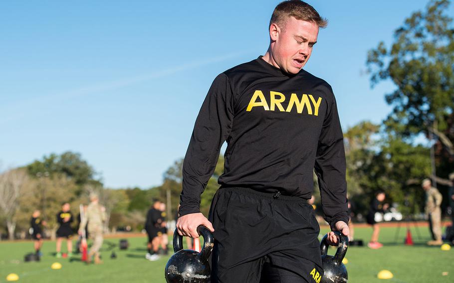 Army Staff Sgt. Brandon Powell carries 40-pound kettle bells during the sprint-drag-carry event, one of six parts of the Army Combat Fitness Test, during a demonstration Tuesday, Oct. 23, 2018 at Fort Eustis, Va.