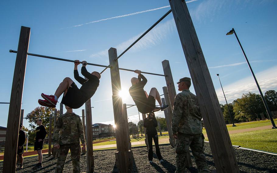Soldiers assigned to the 128th Aviation Brigade at Fort Eustis, Va., attempt the leg tuck portion of the Army's new Army Combat Fitness Test during a demonstration Tuesday, Oct. 23, 2018 at the installation. The six-event test is undergoing testing and is scheduled to be fully implemented across the service by October of 2020.