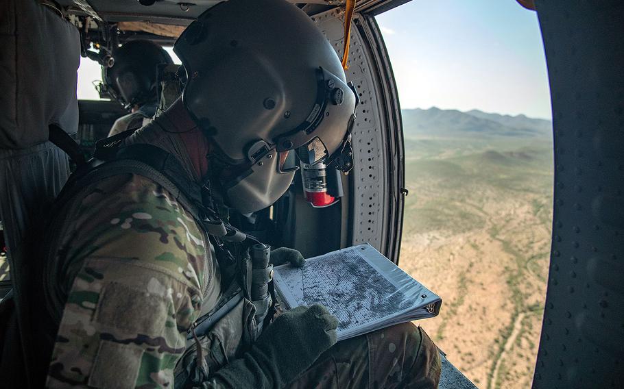 A National Guard crew member consults a map while enroute to a call for assistance by Border Patrol agents on the ground. The UH-60 Blackhawk helicopter crew participated in Tucson Sector’s Mobile Response Team Monday, Aug. 13, 2018.