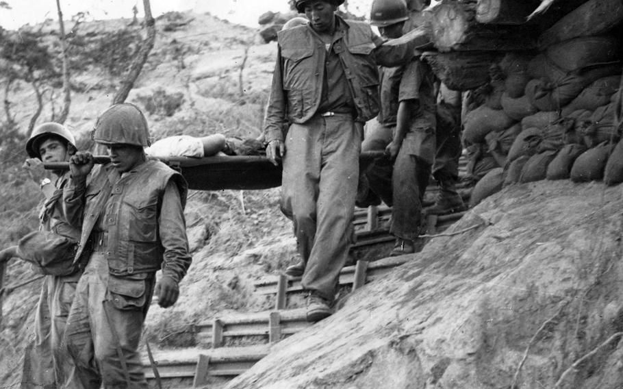 Colombian Battalion infantrymen return from an assault on a Chinese-held hill in Korea on June 21, 1952.