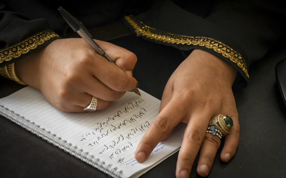 Na'ema Mawdadi, an Afghan police officer since 2007, writes a poem Oct. 29, 2018, at the Herat municipal police headquarters. In the poem, which she wrote after last year's bombing of the German Embassy in Kabul, Mawdadi says goodbye to friends lost, and says goodbye to bad memories as well. 

