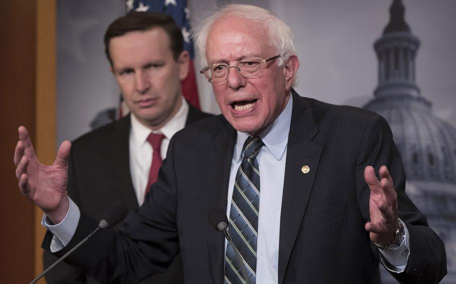 Sen. Bernie Sanders, I-Vt., speaks to reporters on Capitol Hill after the Senate passed a resolution he introduced that would pull assistance from the Saudi-led war in Yemen, Thursday, Dec. 13, 2018. Behind him is Sen. Chris Murphy, D-Conn.