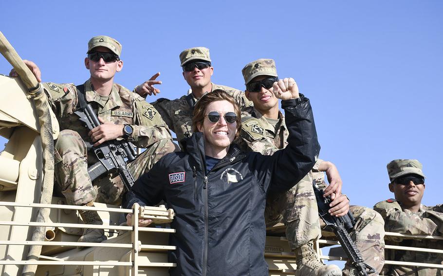 Snowboarder Shaun White poses with troops gathered at a Christmas event with the USO on Monday, Dec. 24, 2018, at Camp Dahlke West in Afghanistan. 

