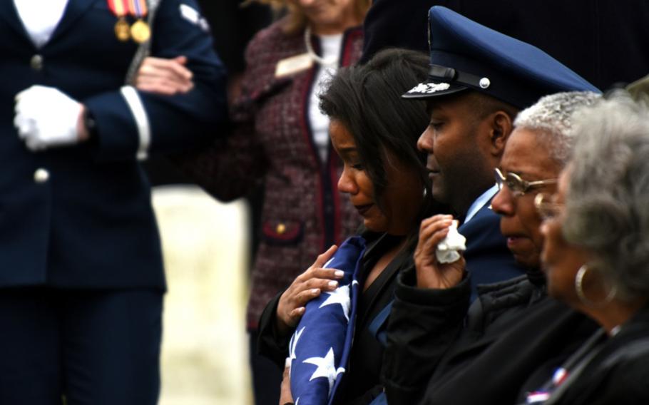 Tenecia Harris, daughter of Marcelite Harris, holds the American flag during her mother’s funeral at Arlington National Cemetery on Feb. 7, 2019. 