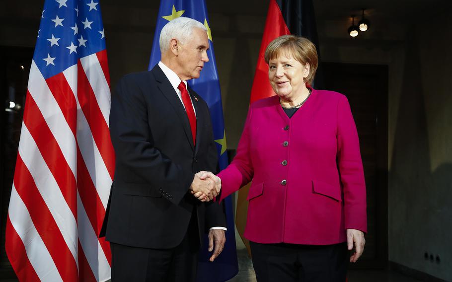 German Chancellor Angela Merkel, right, welcomes United States Vice President Mike Pence, left, for a bilateral meeting during the Munich Security Conference in Munich, Germany, Saturday, Feb. 16, 2019. 