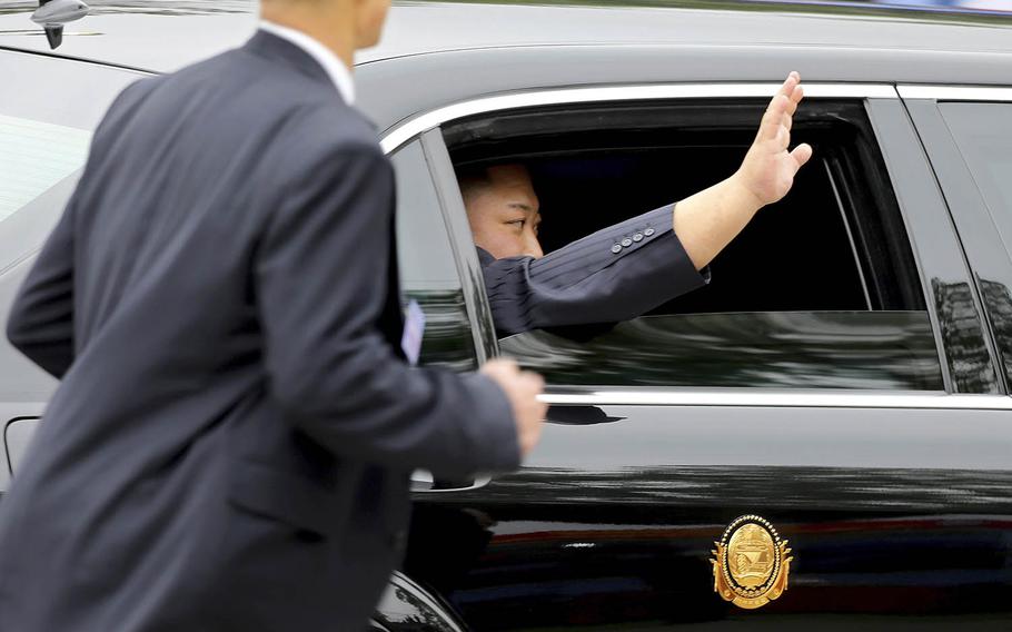 North Korean leader Kim Jong Un waves from a car after arriving by train in Dong Dang in Vietnamese border town Tuesday, Feb. 26, 2019, ahead of his second summit with U.S. President Donald Trump. 