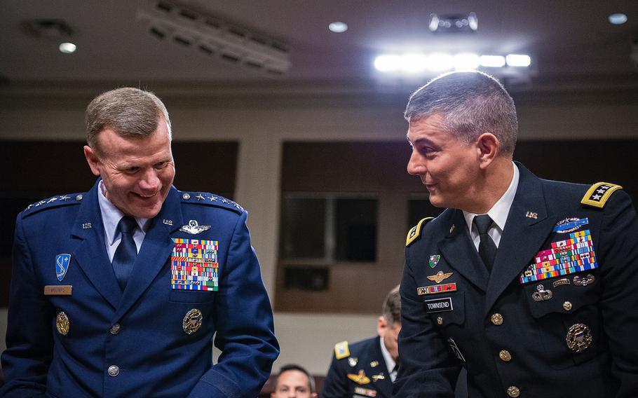 Gen. Tod D. Wolters, left, and Gen. Stephen J. Townsend share a laugh as they prepare to testify Tuesday, April 2, 2019, during a Senate Armed Services Committee hearing on Capitol Hill in Washington. Wolters has been nominated to head the European Command and Townsend to head the Africa Command.