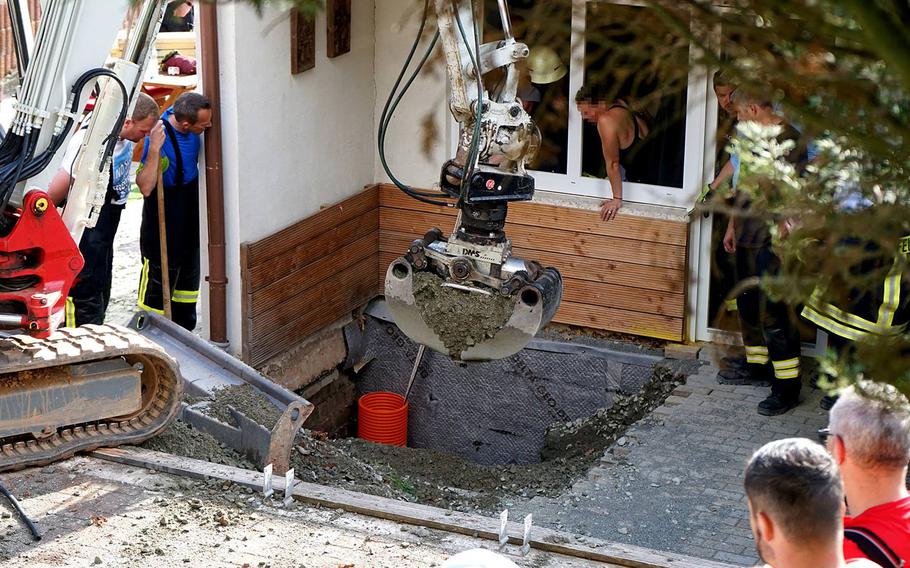 Fire department personnel use a small excavator to rescue a toddler who fell into a nearly 10-foot shaft in Erzenhausen, Germany, just north of Ramstein Air Base, on April 22, 2019.
