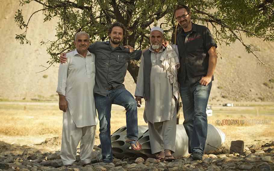 Matt Griffin, his brother-in-law Andy Sewrey, and two relatives of their security team in Afghanistan pose for a photo while on a visit to the tomb of Ahmed Shah Massoud in the Panjshir Valley north of Kabul.