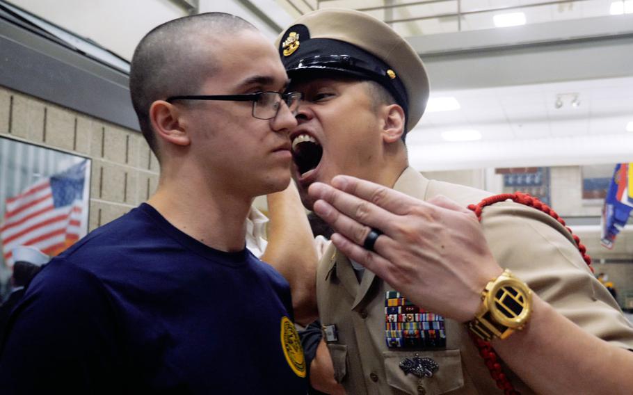 A recruit listens as the recruit division commander yells at him at the Navy's Recruit Training Command in Great Lakes, Ill. Qualified E-5 sailors willing to fill recruiting and boot camp billets now have a non-exam route for promotion. 

