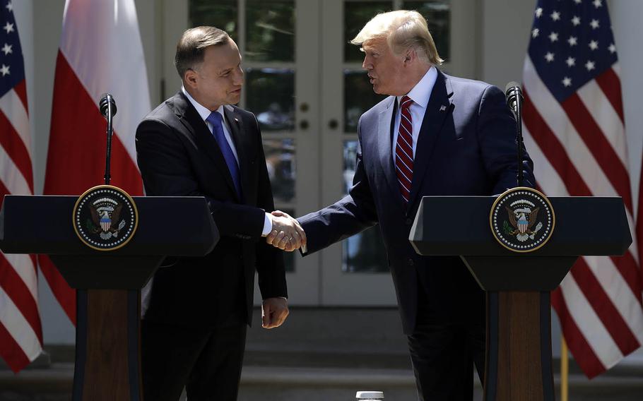 President Donald Trump shakes hands with Polish President Andrzej Duda during a news conference in the Rose Garden of the White House on Wednesday, June 12, 2019, in Washington. 