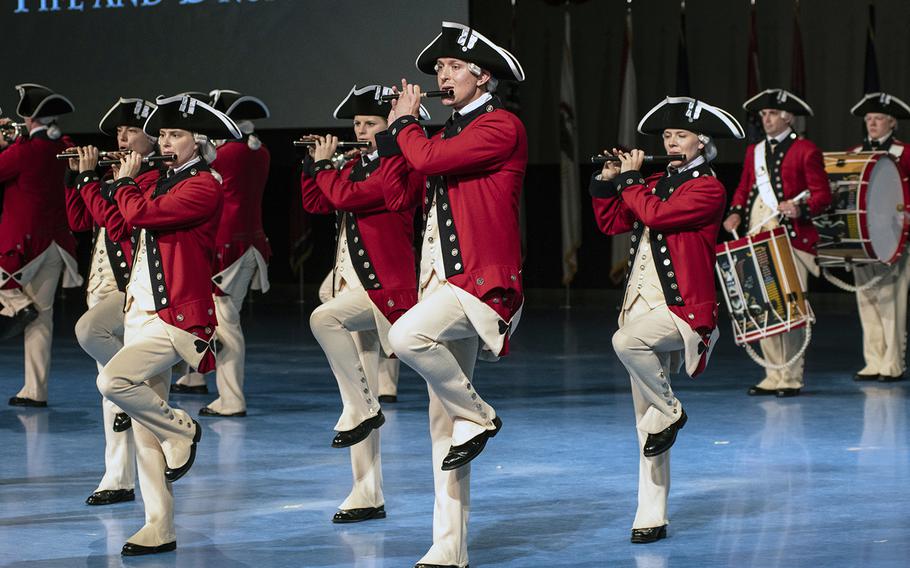 Members of the Old Guard Fife and Drum Corps play a patriotic tune in Revolutionary War-style uniforms during the Twilight Tattoo on June 19 at Joint Base Myer-Henderson in Arlington, Virginia.