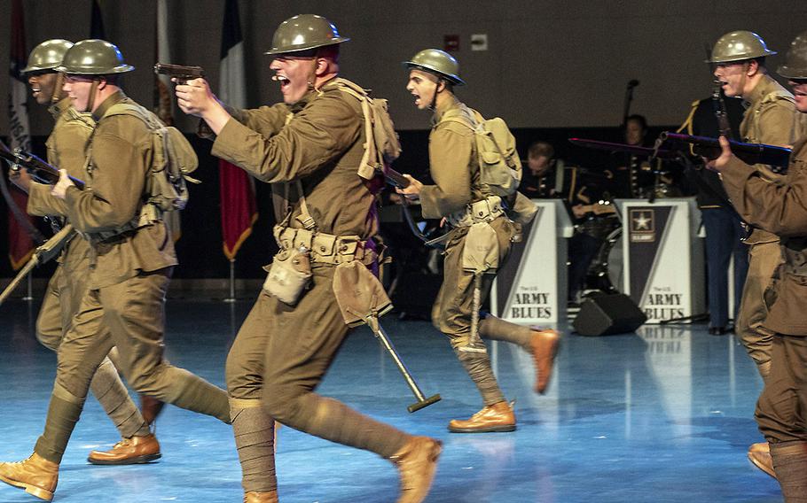 Dressed as soldiers from World War I, members of the Old Guard run on stage during the Twilight Tattoo on June 19 at Joint Base Myer-Henderson in Arlington, Virginia.