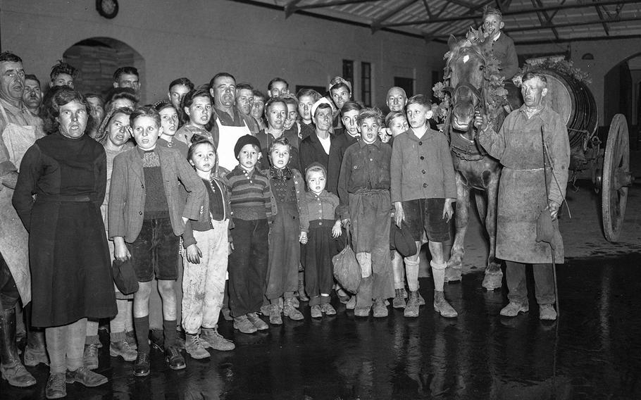 Pickers assemble to sing as the last load of the 1947 harvest is brought in.