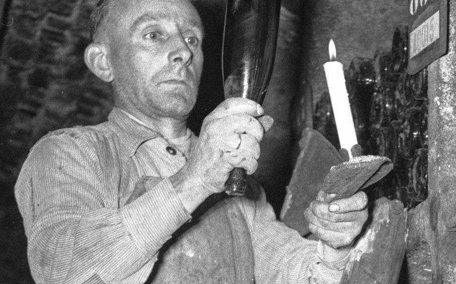 A worker in the wine cellar of the Weingut Louis Guntrum.