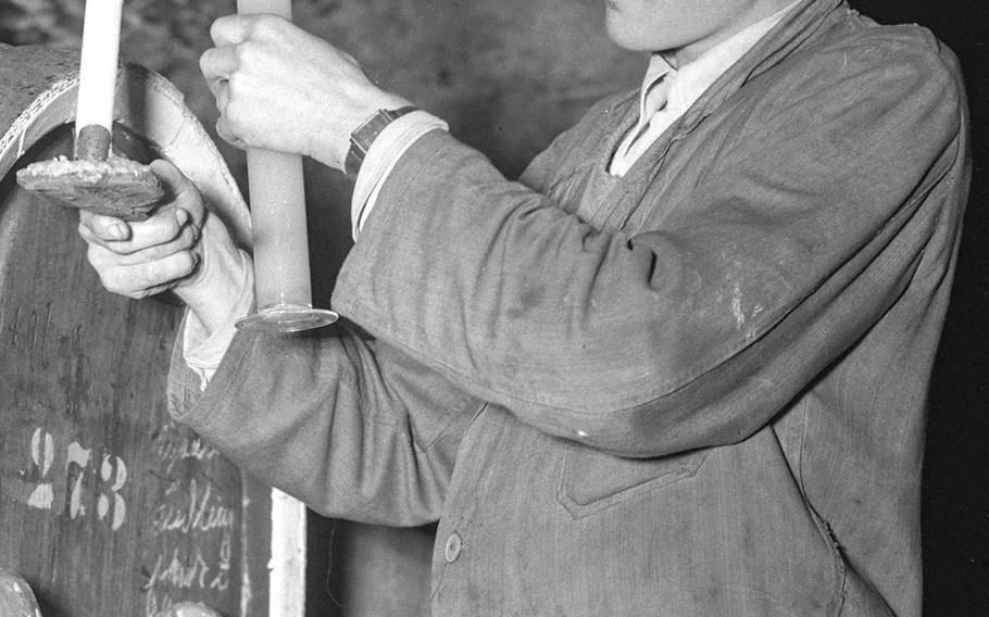 An expert tests a sample of juice for its sugar content.