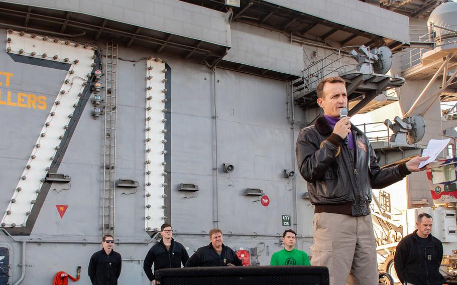 In a Dec. 15, 2019 photo, Capt. Brett Crozier, commanding officer of the aircraft carrier USS Theodore Roosevelt, gives remarks during an all-hands call on the ship's flight deck.