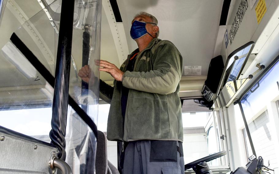 Lui Selinski, a member of the Allied Trades machine shop at Ramstein Air Base, Germany, inspects a plastic sheet barrier installed inside a bus belonging to the 86th Vehicle Readiness Squadron, May 12, 2020.


