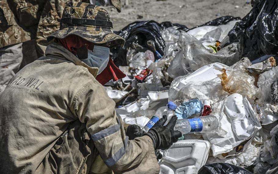 Workers pick through trash from the U.S. Embassy in Kabul on Aug. 17, 2020 at what the Afghan government says is an illegal dump, two miles east of the airport.