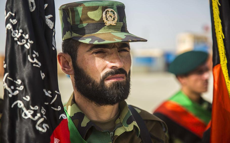 In a July 14, 2018 photo, an Afghan National Army soldier stands at attention during 2nd Kandak, 2nd Brigade's Operational Readiness Cycle graduation ceremony at Camp Shorabak in Helmand province.  Hundreds have died after the Taliban launched an offensive in the area in mid-October, leading the U.S. to conduct airstrikes against the militants, officials and news reports said on October 14, 2020.