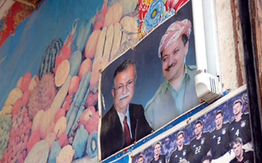 A photo of Iraqi President Jalal Talabani and Kurdistan Regional Government President Masoud Barzani hangs next to advertisements and posters of famous soccer teams Wednesday at a vegetable store in Khaniqin, Iraq. Photos of the two Kurdish leaders are plastered across the area’s shops and government buildings, while the faces of Arab leaders like Prime Minister Nouri al-Maliki are entirely absent.