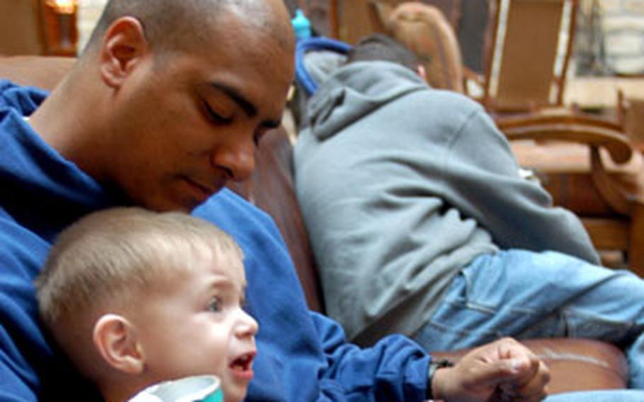 Spc. Juan Colon of 7th Battalion, 159th Aviation Regiment, out of Illesheim, Germany, relaxes with 21-month-old Joshua Martinez, the son of another Illesheim-based soldier, at the Edelweiss Lodge and Resort in Garmisch, Germany. Colon was on block leave following a one-year deployment to Iraq.