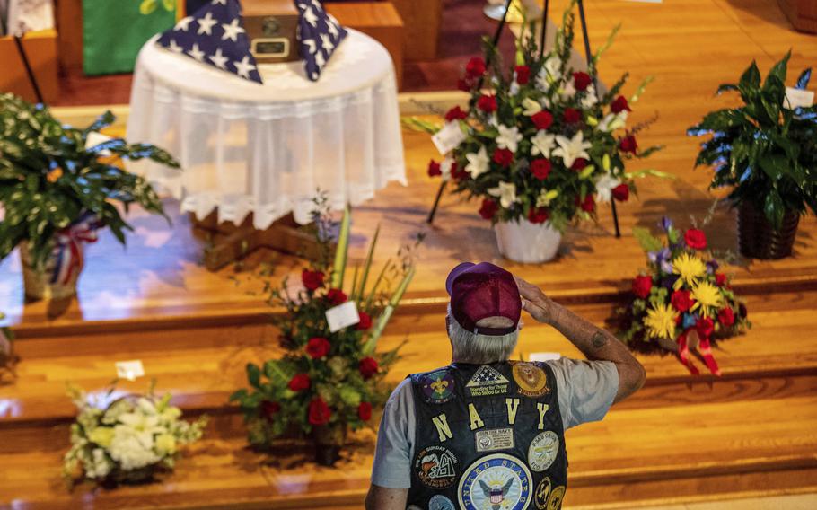 In this Thursday, Sept. 16, 2021, photo, David Gibbs Sr. salutes during the public visitation for Marine Cpl. Daegan Page at St. Paul Lutheran Church in Omaha, Neb. Gibbs, a Navy veteran, served 26 years. Cpl. Page was one of 13 U.S. service members killed Aug. 26 in a suicide bombing at the Kabul airport during the U.S. evacuation from Afghanistan.