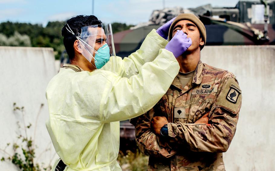 A U.S. Army medic paratrooper assigned to the 173rd Airborne Brigade swabs a soldier for the coronavirus at Hohenfels Training Area, Germany, Aug. 20, 2020, during Exercise Saber Junction 20.

