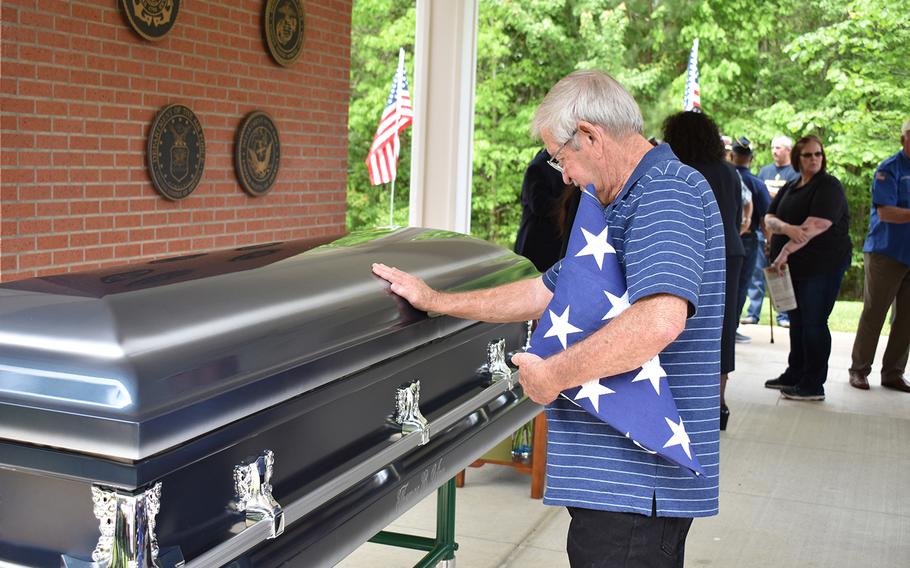 Thomas Staggs puts his hand on the casket of his friend, former Army Pfc. Thomas Bernard Winn, during his funeral on April 17, 2019, at the Central Louisiana Veterans Cemetery in Leesville. Winn died April 2 at age 65. The state was unable to identify any relatives, so the Louisiana Department of Veterans Affairs worked with local charities to bury Winn with full military honors and  to provide a funeral. 