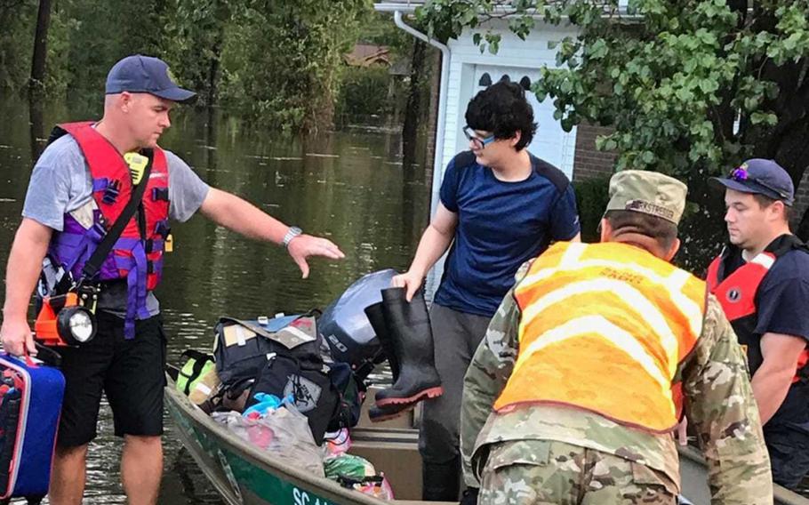 A soldier with the South Carolina Army National Guard assists Conway Fire Search and Rescue teams with rescue efforts in Conway, S.C., in the aftermath of Hurricane Florence, Sept. 17, 2018.