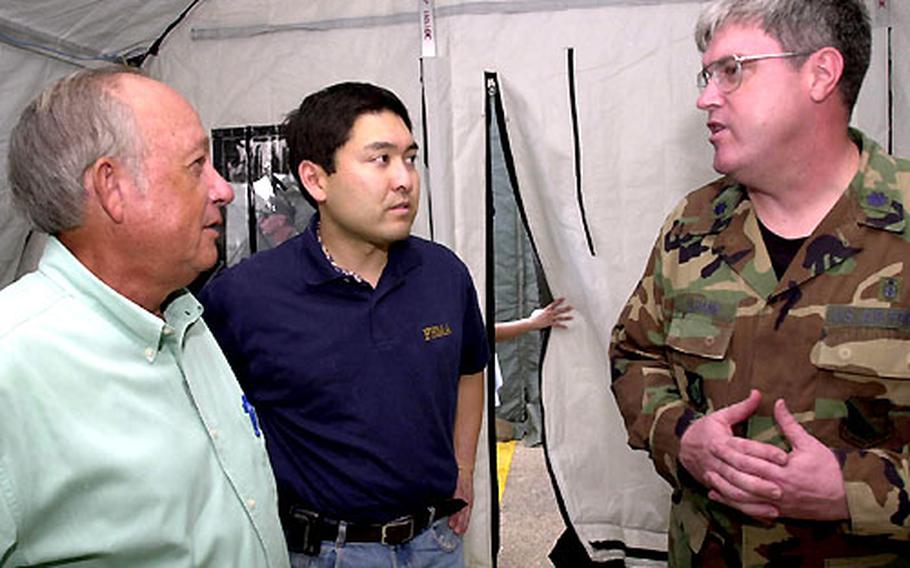 Air Force Lt. Col. Mike Culhane shows off his field hospital to Guam Gov. Carl Gutierrez, left, and David Fukutomi, the Federal Emergency Management Agency&#39;s federal coordination officer.
