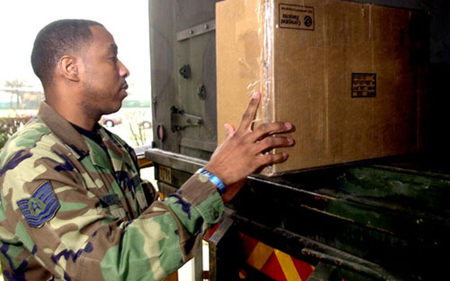 Tech. Sgt. Will Smith loads packages onto a truck at the Rhein-Main Post Office.